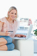 Portrait of a blonde buying online with a laptop