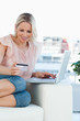 Blonde buying online on a laptop