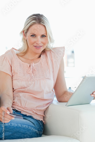 Photo: Portrait of a blonde buying online with a touchpad Portrait of a blonde buying online with a touchpad