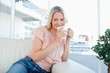 Smiling blonde with a coffee