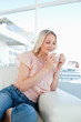 Blonde smelling her herbal tea