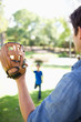 Father uses the baseball glove to catch the ball
