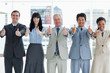 Photo: Business people showing their approval by putting their thumbs up Business people showing their approval by putting their thumbs up