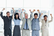 Photo: Five business people showing their approval with their arms raised above their head Five business people showing their approval with their arms raised above their head