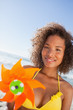 Smiling woman holding a pinwheel in front of her