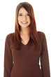 Young beautiful woman is looking straight and smiling.
