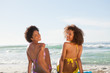 Rear view of young women turning their head back