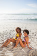 Overhead view of young attractive women sitting on the sand