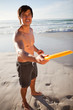 Photo: Young attractive man playing frisbee on the beach Young attractive man playing frisbee on the beach