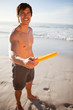 Photo: Handsome man playing frisbee in swimsuit Handsome man playing frisbee in swimsuit