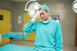 Tired nurse sitting on the operating table