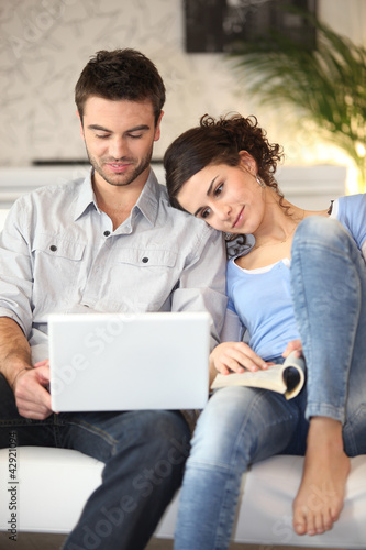Photo: Couple sitting on sofa Couple sitting on sofa