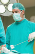 Serious surgeon looking at something