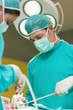 View of a serious surgeons holding surgical tools