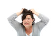 Woman looking stressed, pulling her hair out.