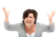 Distraught woman with her hands raised against white background.