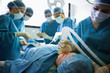Unconscious patient being operated by surgeons