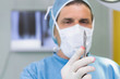 Focus surgeon holding a scalpel in his hand
