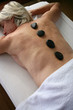 Foto: Older woman enjoying a hot stone massage Older woman enjoying a hot stone massage