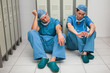 Two surgeons sitting in a locker room