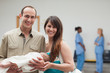 Smiling couple holding a new born baby