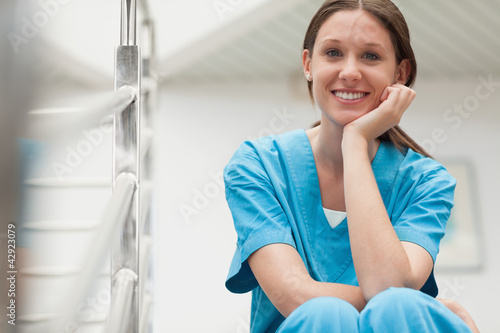 Photo: Smiling woman sitting on stairs Smiling woman sitting on stairs
