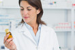Female pharmacist looking at pills in a pharmacy