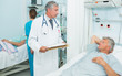 Doctor and nurse talking with patients in a bed