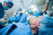Medical team in an operating theater operating an unconscious patient