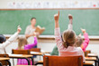 Elementary students rising hands