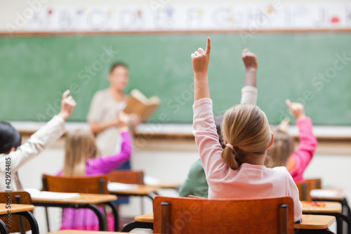 Photo: Elementary students rising hands Elementary students rising hands