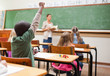 Back view of pupil raising hand
