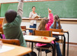 Back view of pupils raising hands