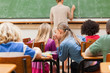 Back view of elementary school students talking
