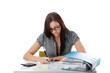 Photo: Young woman in glasses sitting at desk and working Young woman in glasses sitting at desk and working