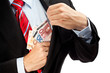 Businessman putting money in his pocket.