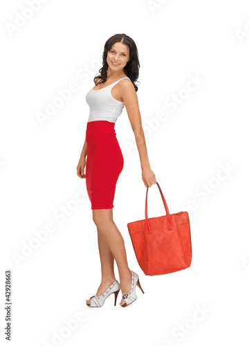 Photo: woman in dress with a bag woman in dress with a bag