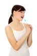 Young, singing woman with toothbrush