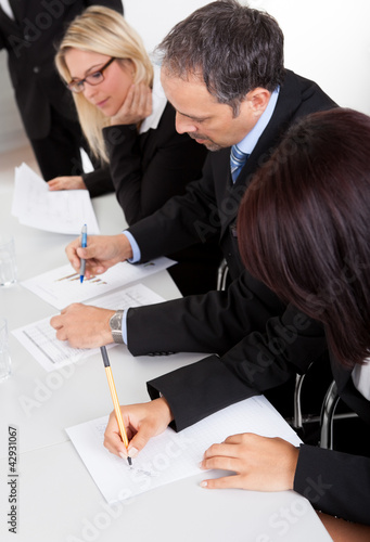Photo: Business people taking notes Business people taking notes