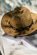 Book and straw hat on deckchair