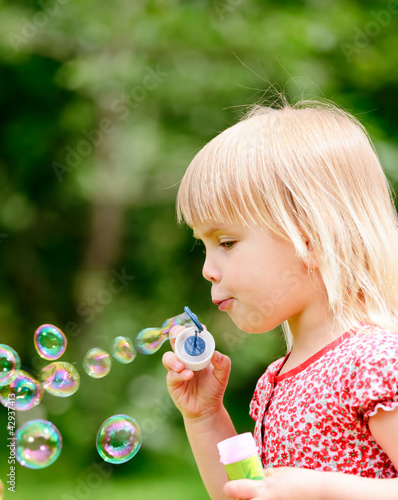 Photo: Little girl making bubbles Little girl making bubbles