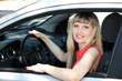 Photo: Happy smiling blonde woman in car Happy smiling blonde woman in car