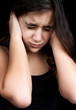 Portrait of a frightened hispanic  girl isolated on black