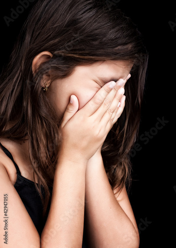 Photo: Beautiful hispanic girl crying and covering her face Beautiful hispanic girl crying and covering her face