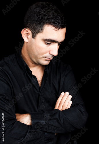 Photo: Hispanic man with a sad and thoughtful expression Hispanic man with a sad and thoughtful expression