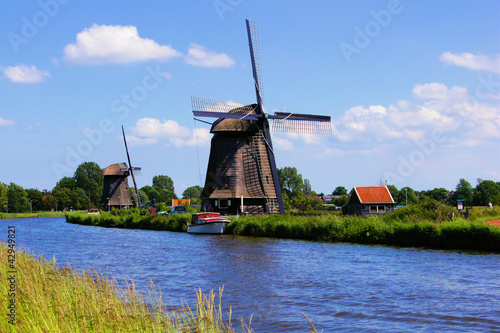 Photo: Dutch windmills along a canal near Alkmaar, Netherlands Dutch windmills along a canal near Alkmaar, Netherlands