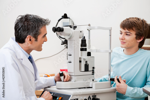 Photo: Boy Consulting Doctor After Visual Field Test Boy Consulting Doctor After Visual Field Test