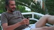 brunette man text massage cellphone on the terrace