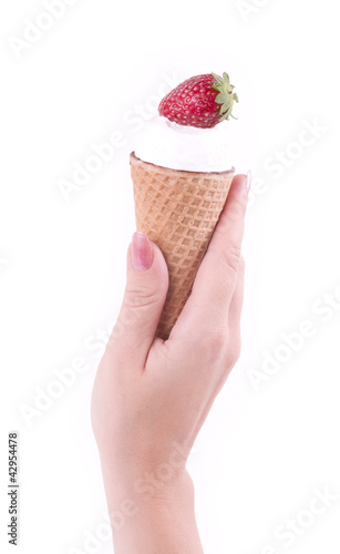 Photo: Female hand holding ice cream with strawberry Female hand holding ice cream with strawberry