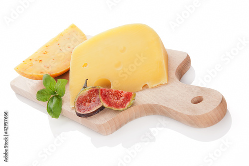 Photo: Cheese variaton on chopping board isolated. Cheese variaton on chopping board isolated.